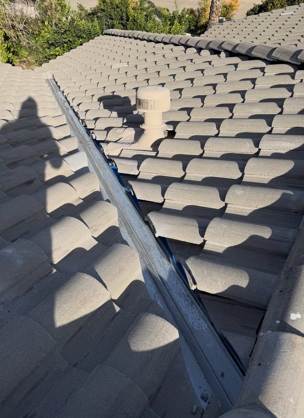 Concrete tile roof with ridge caps and valley flashing