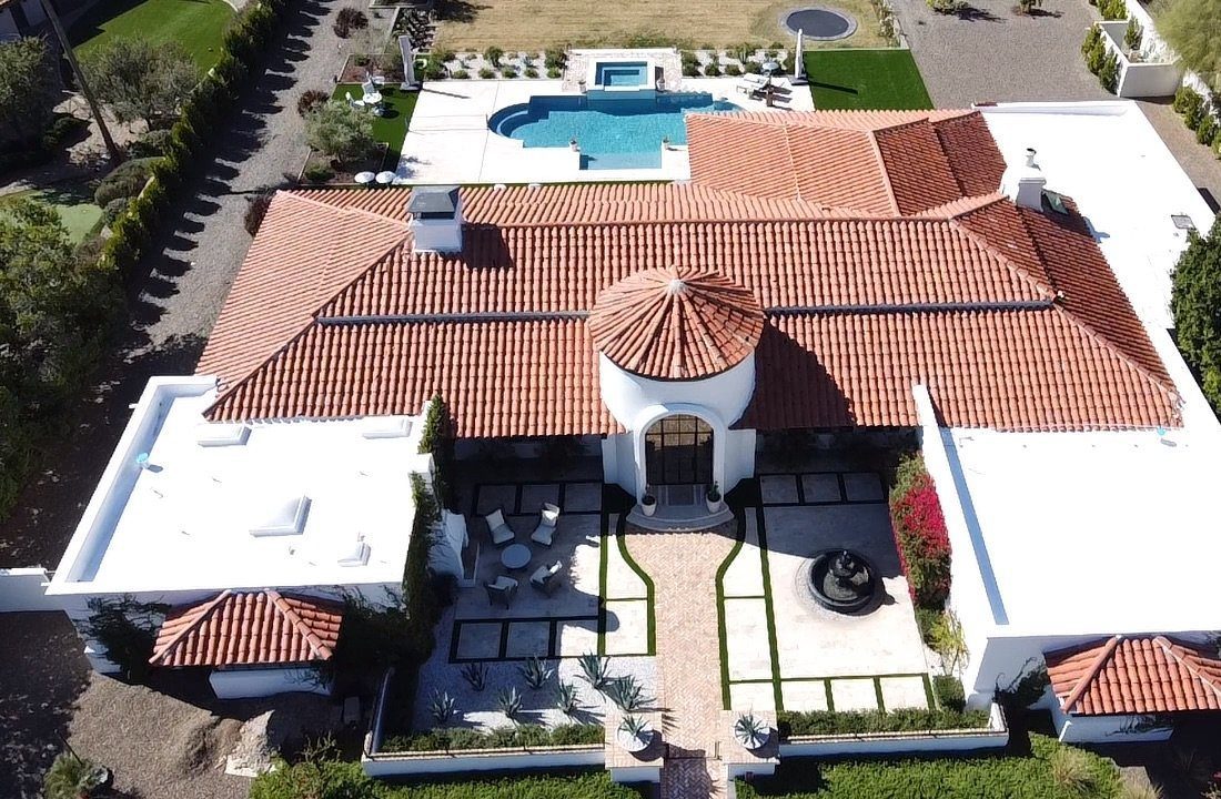 Aerial of a Paradise Valley home with a red clay barrel-tile roof and pool