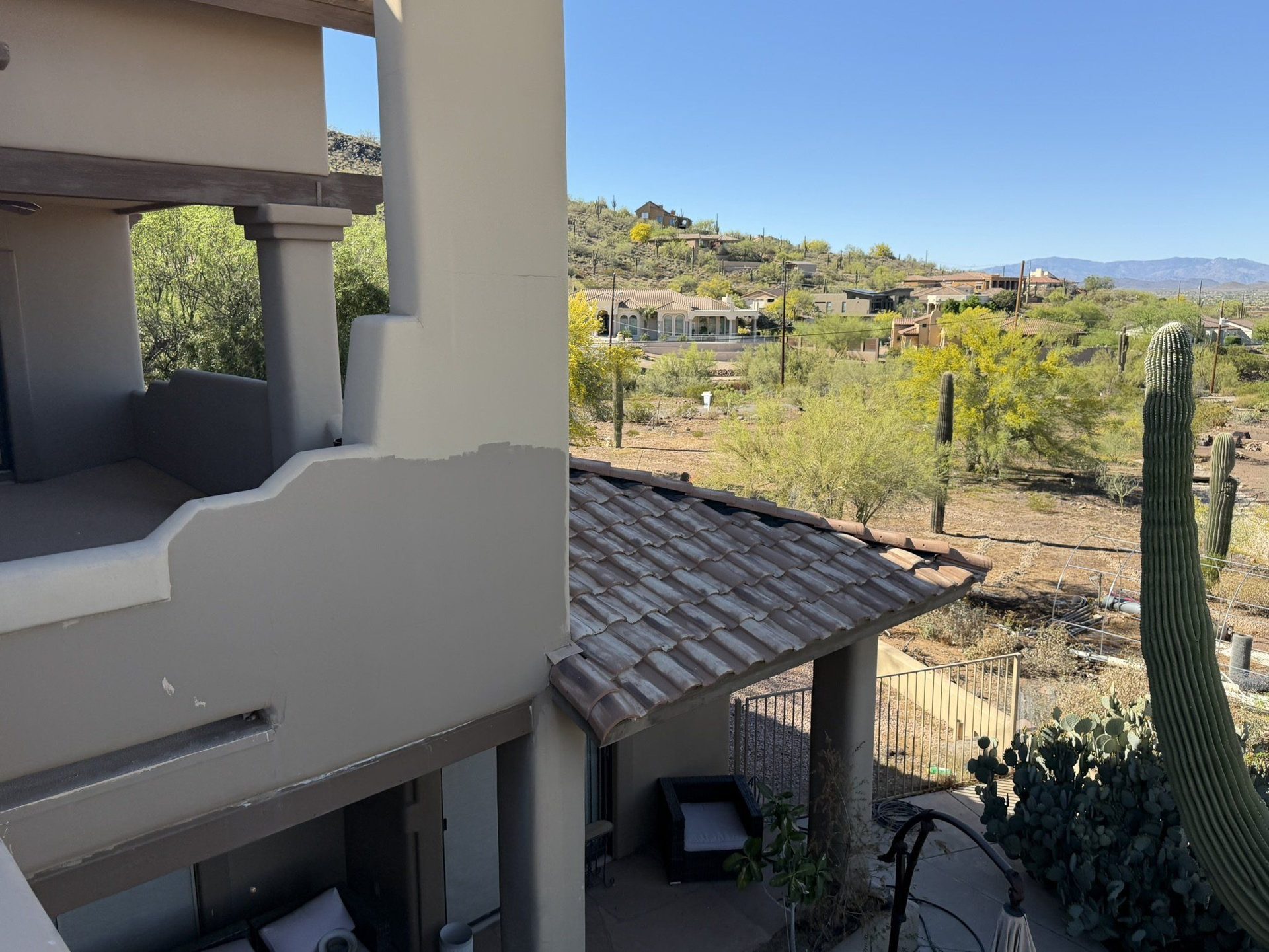 Desert with saguaros seen from a tile roof