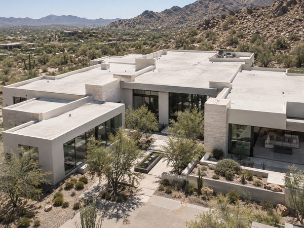Elevated view of a large Paradise Valley desert-modern residence with broad clean white flat roof planes.