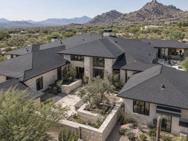 Elevated view of a large Arizona custom estate with expansive charcoal shingle roof planes.
